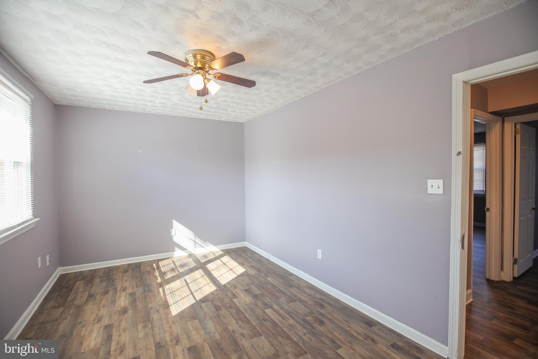 1705 Addison Road South District Heights, MD 20747 - Photo 23 of 26 wooden floor in an empty room with a window