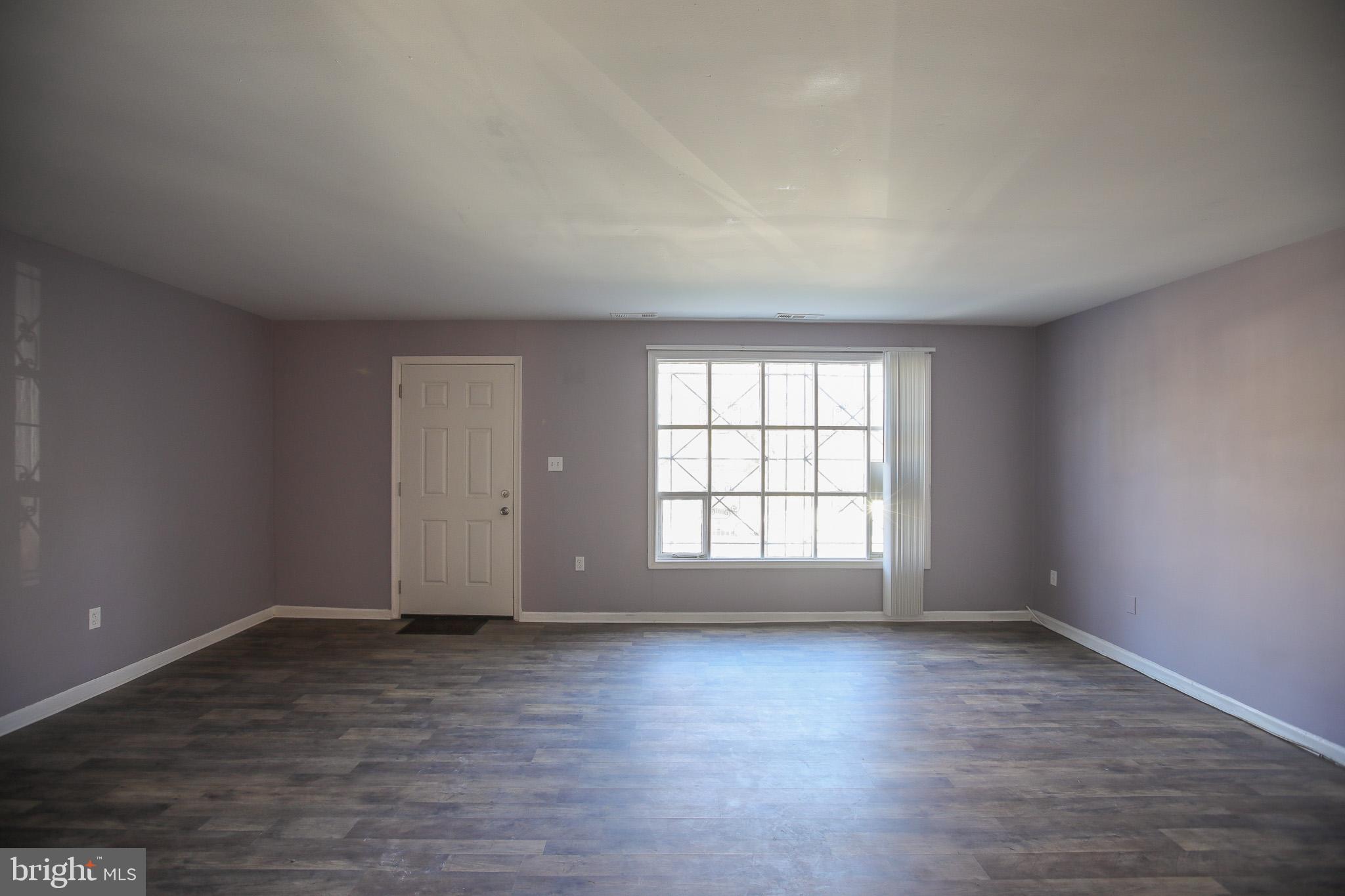 1705 Addison Road South District Heights, MD 20747 - Photo 4 of 26 an empty room with wooden floor and window