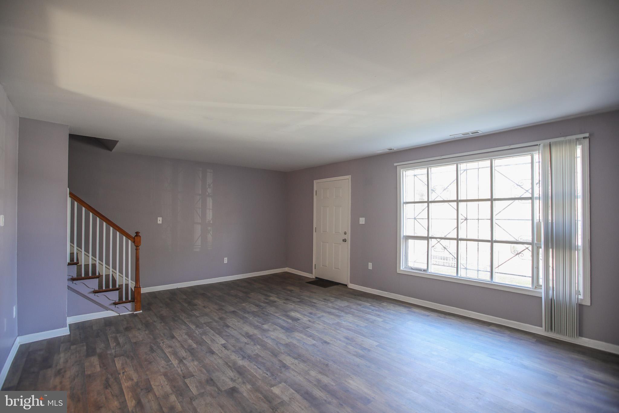 1705 Addison Road South District Heights, MD 20747 - Photo 6 of 26 wooden floor in an empty room with a window