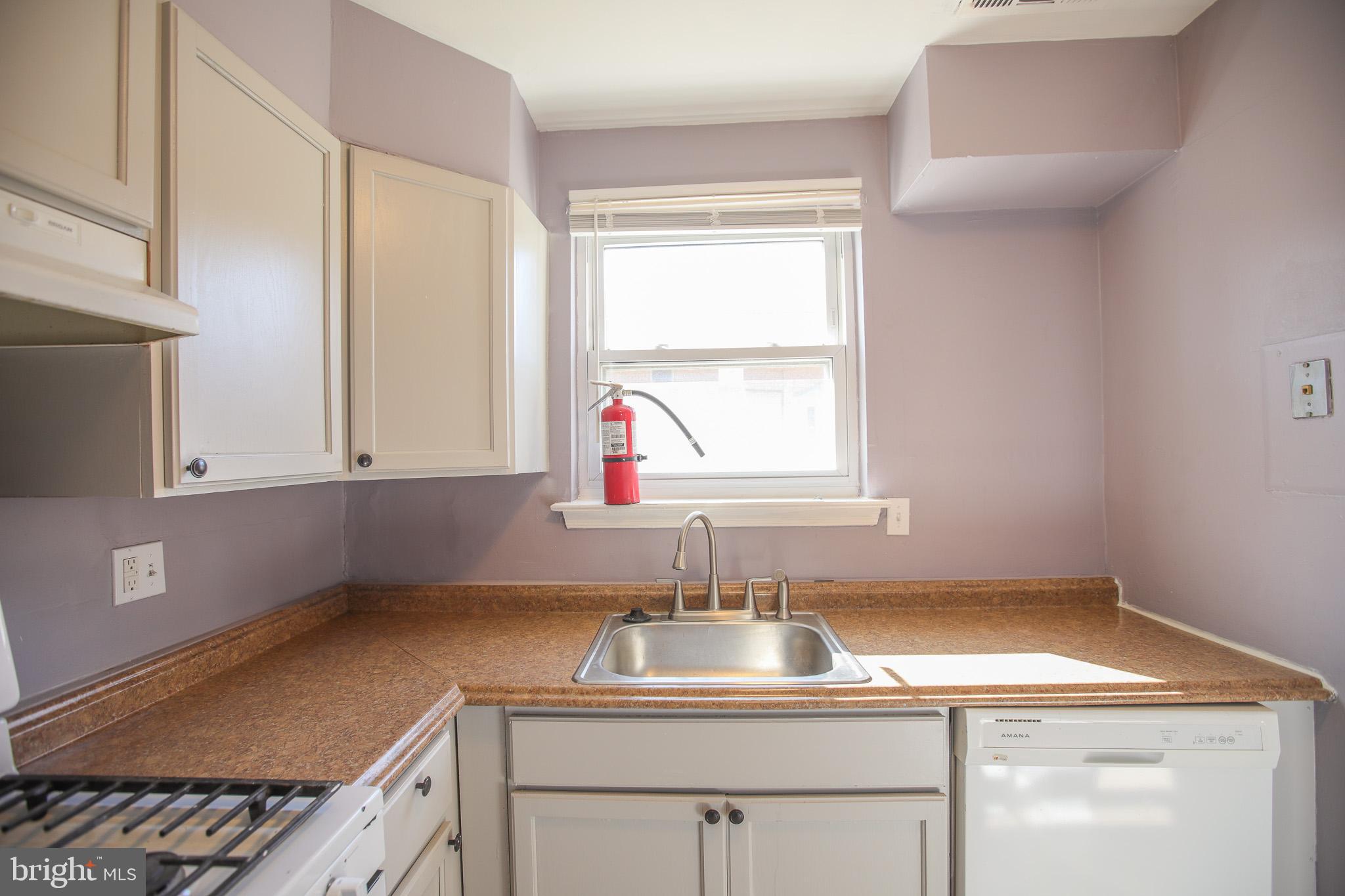 1705 Addison Road South District Heights, MD 20747 - Photo 9 of 26 a kitchen with a sink cabinets and window