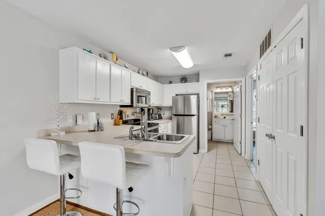 a kitchen with stainless steel appliances a sink stove and refrigerator