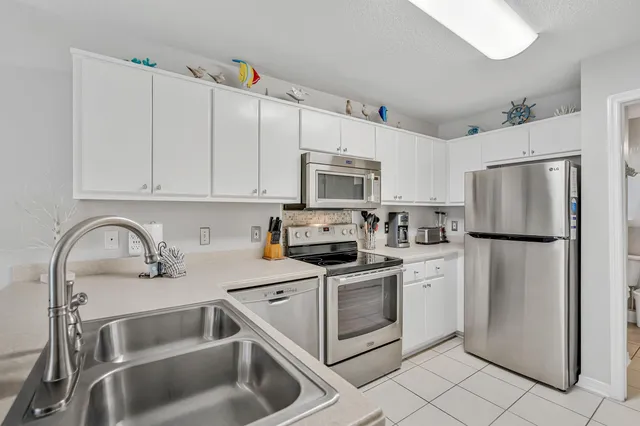 a kitchen with refrigerator a microwave and cabinets