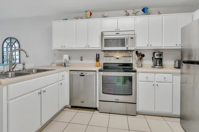 a kitchen with cabinets appliances and a sink
