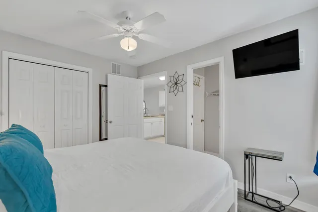 a bedroom with a bed a window and a television