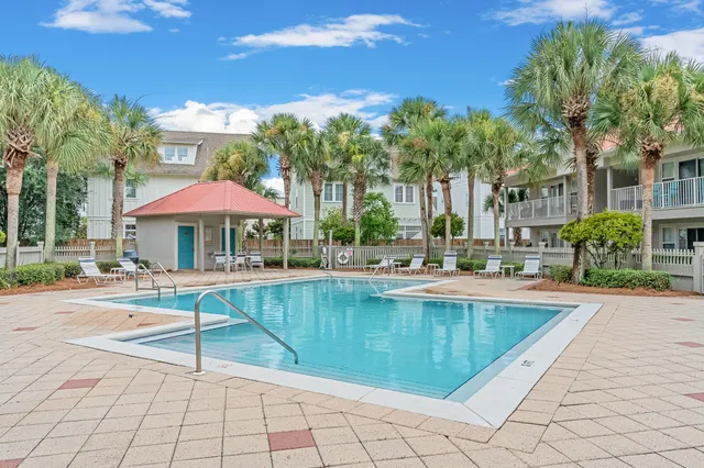 a view of a swimming pool with chairs in patio