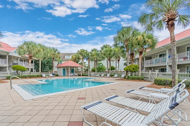 a view of a patio with a table and chairs under an umbrella