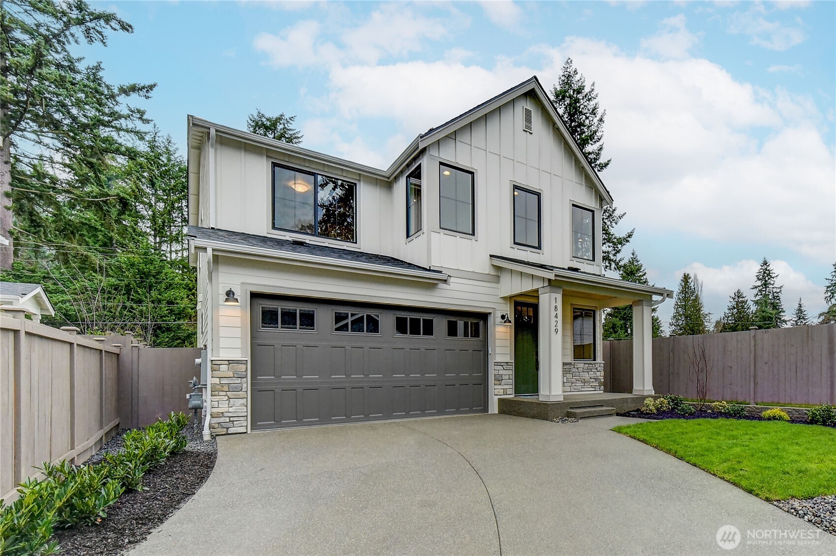 18425 Meridian Avenue Southeast, Unit CR 26 Bothell, WA 98012 - Photo 1 of 35 a front view of a house with a garden and garage