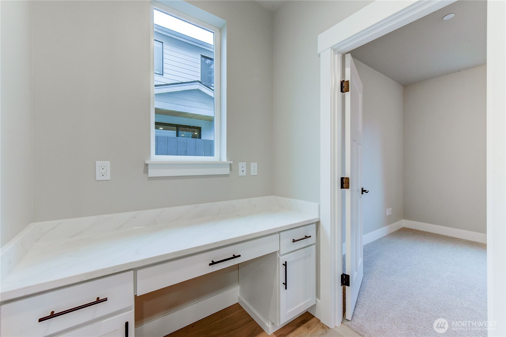 18425 Meridian Avenue Southeast, Unit CR 26 Bothell, WA 98012 - Photo 11 of 35 a room with a wooden floor and cabinets