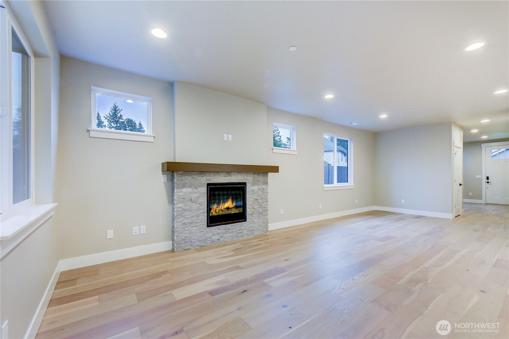 18425 Meridian Avenue Southeast, Unit CR 26 Bothell, WA 98012 - Photo 13 of 35 an empty room with wooden floor a fireplace and windows