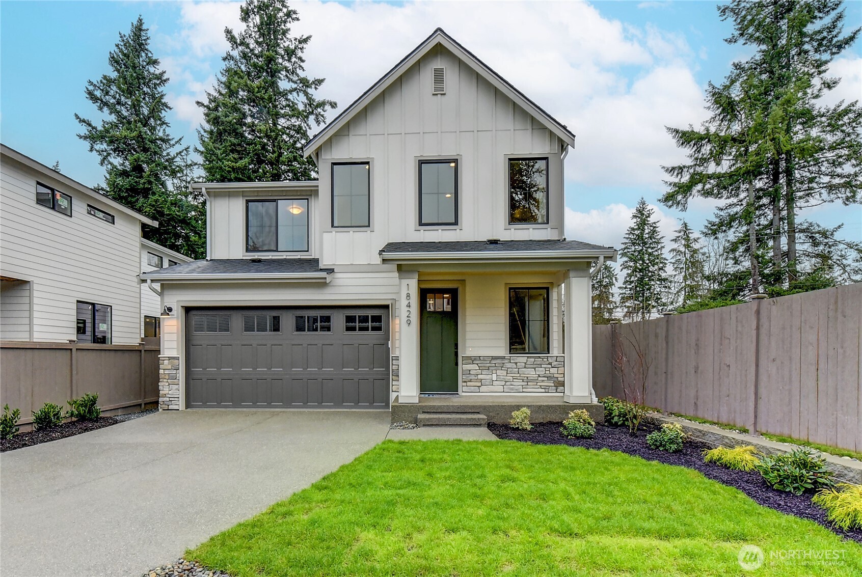 18425 Meridian Avenue Southeast, Unit CR 26 Bothell, WA 98012 - Photo 2 of 35 a front view of a house with a garden and garage
