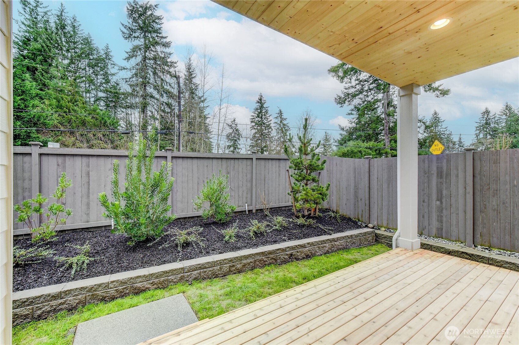 18425 Meridian Avenue Southeast, Unit CR 26 Bothell, WA 98012 - Photo 32 of 35 a view of a backyard with plants and a large tree