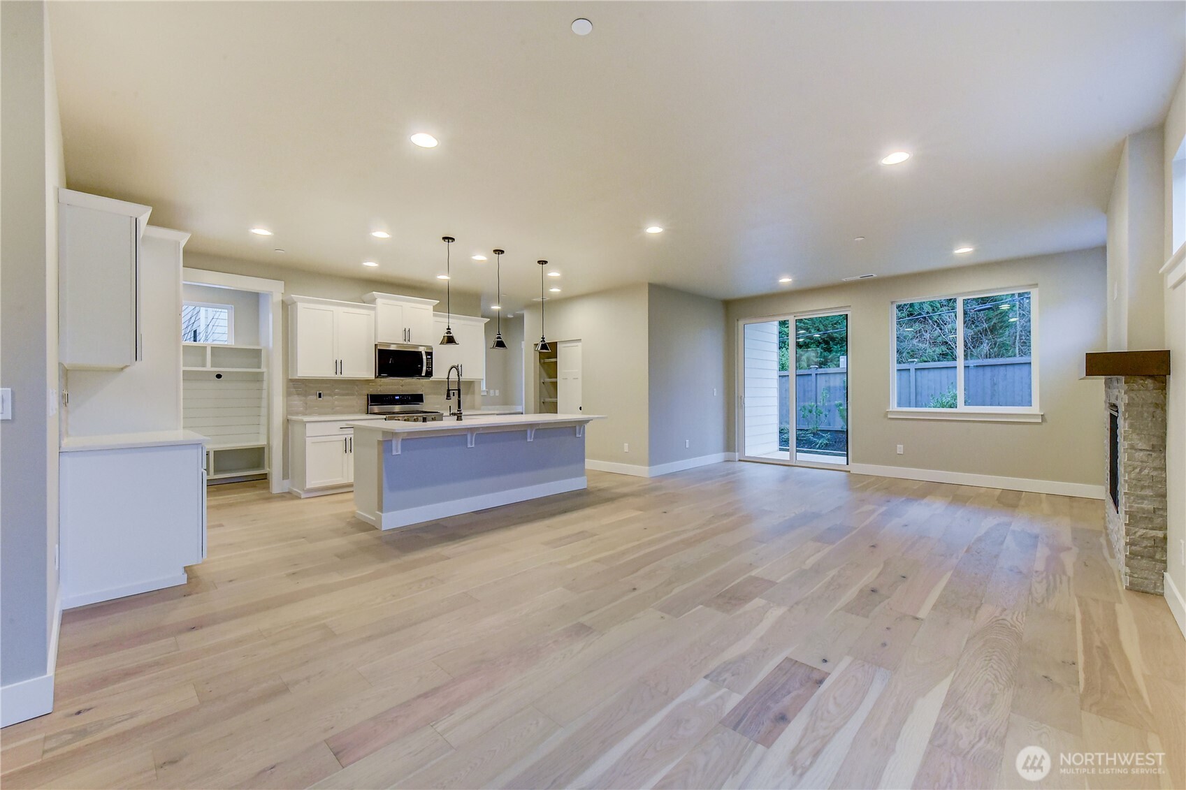 18425 Meridian Avenue Southeast, Unit CR 26 Bothell, WA 98012 - Photo 6 of 35 a large kitchen with stainless steel appliances granite countertop a large counter top a stove and a wooden floors