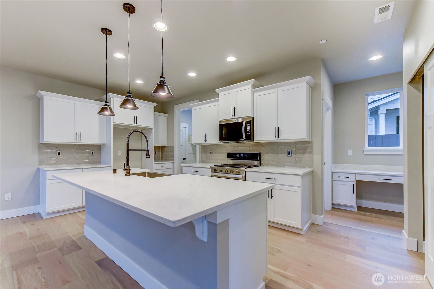 18425 Meridian Avenue Southeast, Unit CR 26 Bothell, WA 98012 - Photo 10 of 35 a large kitchen with kitchen island a sink counter top space appliances and cabinets