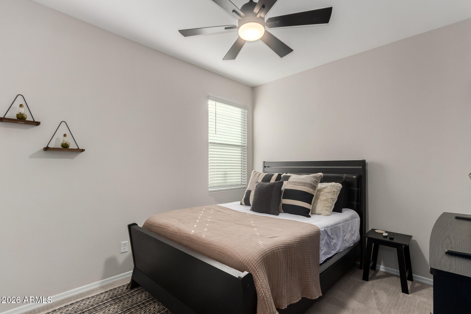 10329 West Gaby Road Tolleson, AZ 85353 - Photo 15 of 22 a bedroom with a bed and window