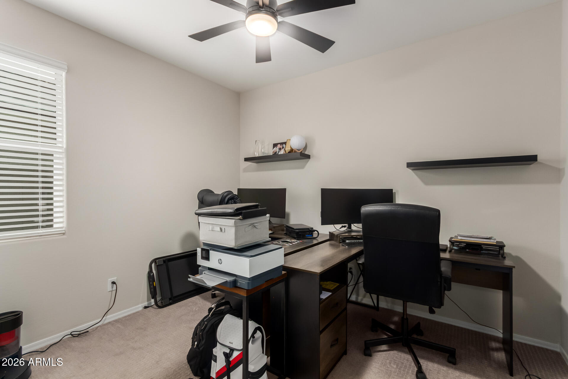 10329 West Gaby Road Tolleson, AZ 85353 - Photo 16 of 22 a view of a workspace with furniture and a window