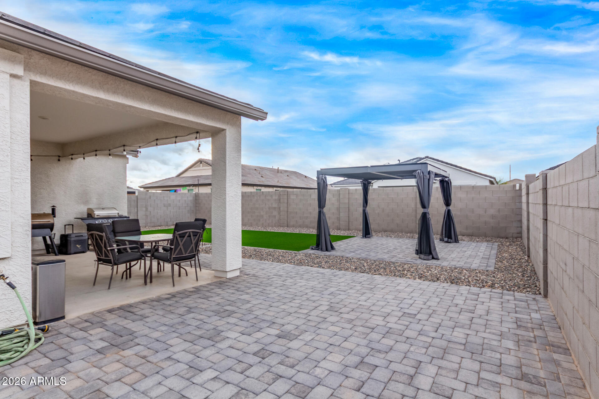 10329 West Gaby Road Tolleson, AZ 85353 - Photo 20 of 22 a view of a patio with table and chairs with wooden fence