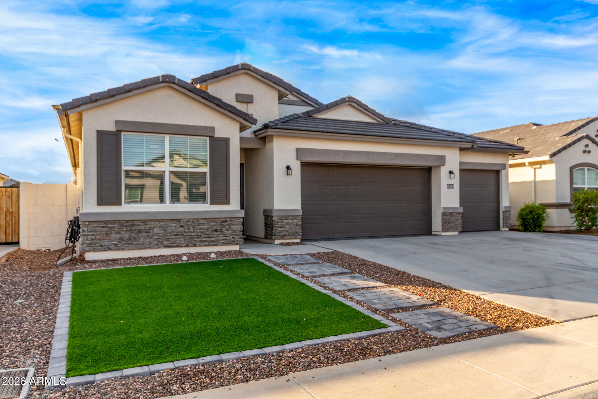 10329 West Gaby Road Tolleson, AZ 85353 - Photo 2 of 22 a front view of a house with a yard and garage