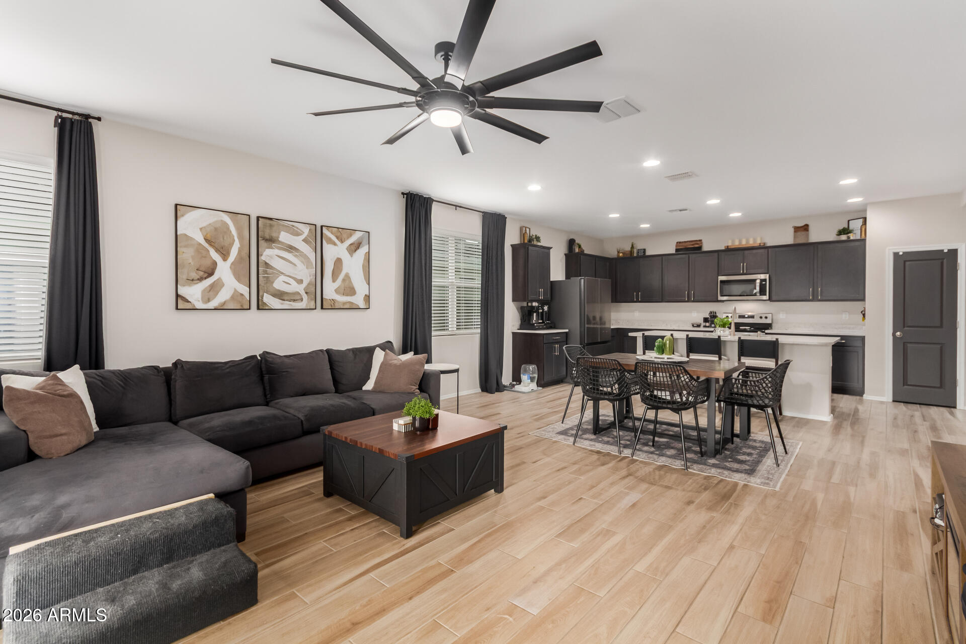 10329 West Gaby Road Tolleson, AZ 85353 - Photo 3 of 22 a living room with furniture kitchen view and a chandelier