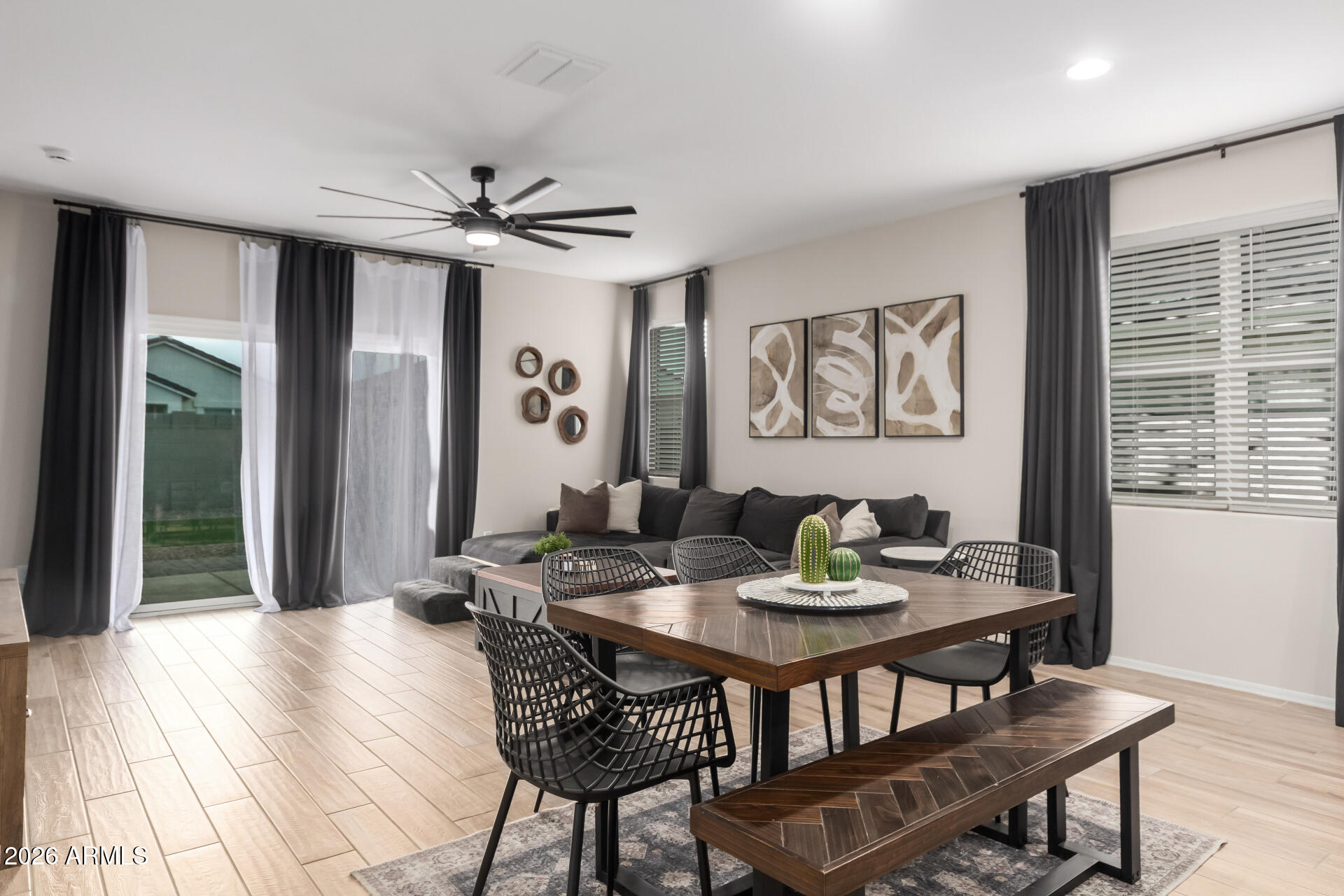 10329 West Gaby Road Tolleson, AZ 85353 - Photo 5 of 22 a view of a dining room with furniture window and wooden floor