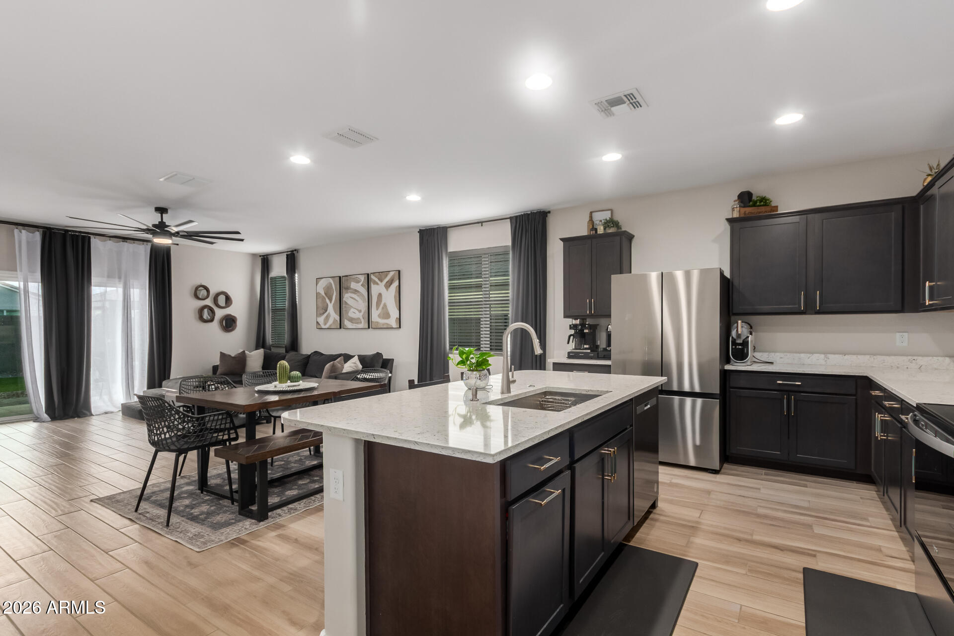 10329 West Gaby Road Tolleson, AZ 85353 - Photo 6 of 22 a kitchen with stainless steel appliances granite countertop a sink stove and refrigerator