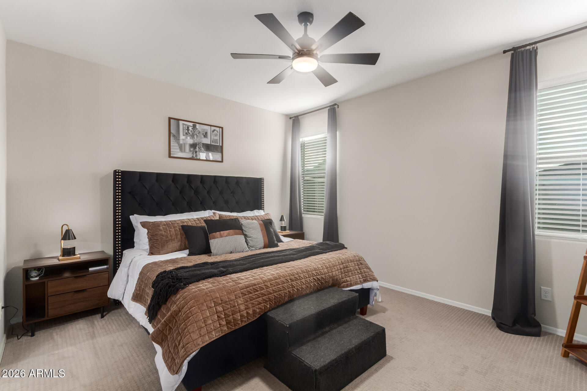 10329 West Gaby Road Tolleson, AZ 85353 - Photo 8 of 22 a bedroom with a bed and a ceiling fan