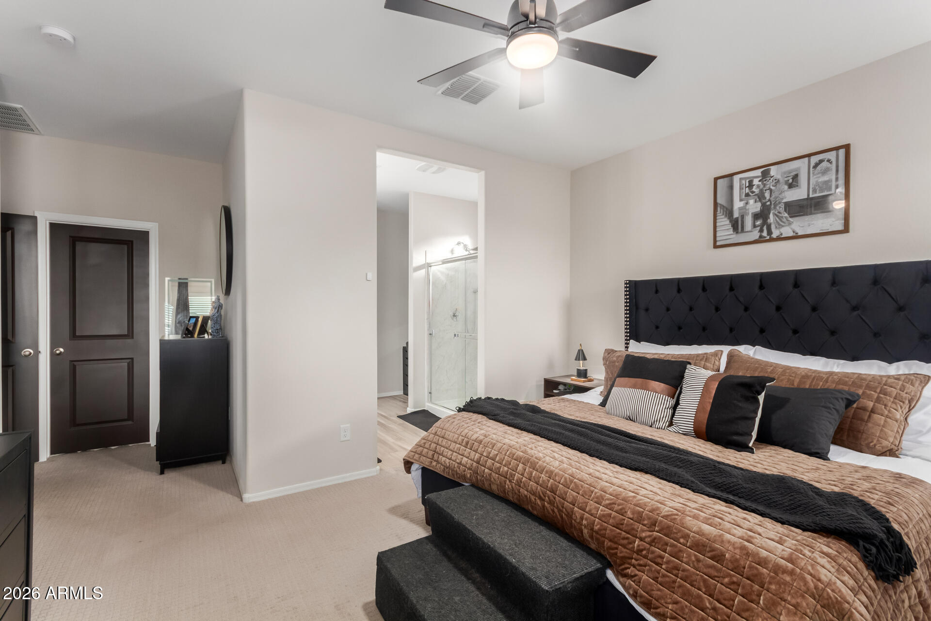 10329 West Gaby Road Tolleson, AZ 85353 - Photo 9 of 22 a bedroom with a large bed and a chandelier