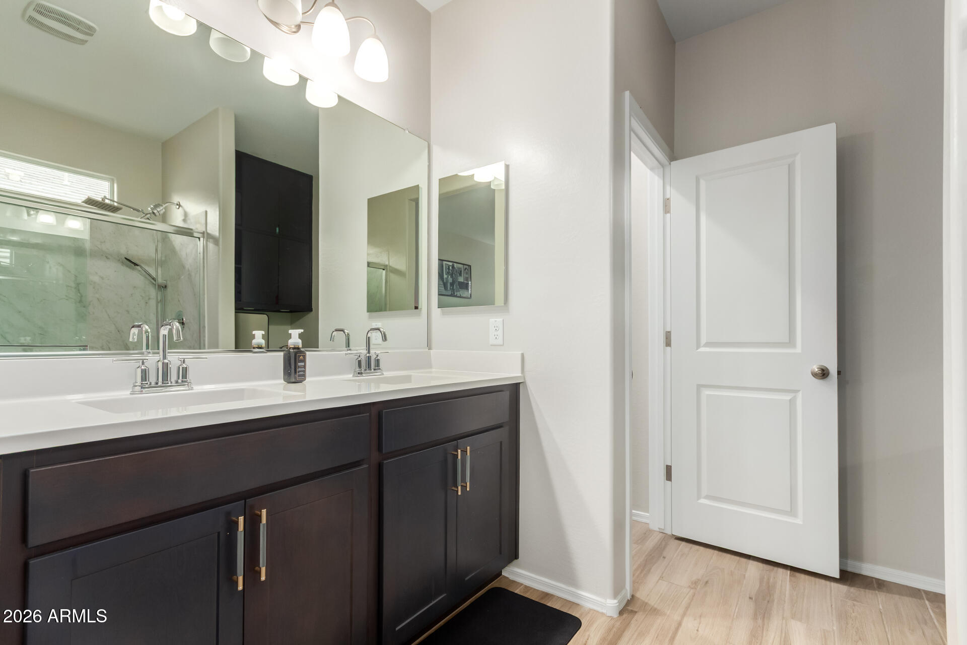 10329 West Gaby Road Tolleson, AZ 85353 - Photo 10 of 22 a bathroom with a double vanity sink and mirror