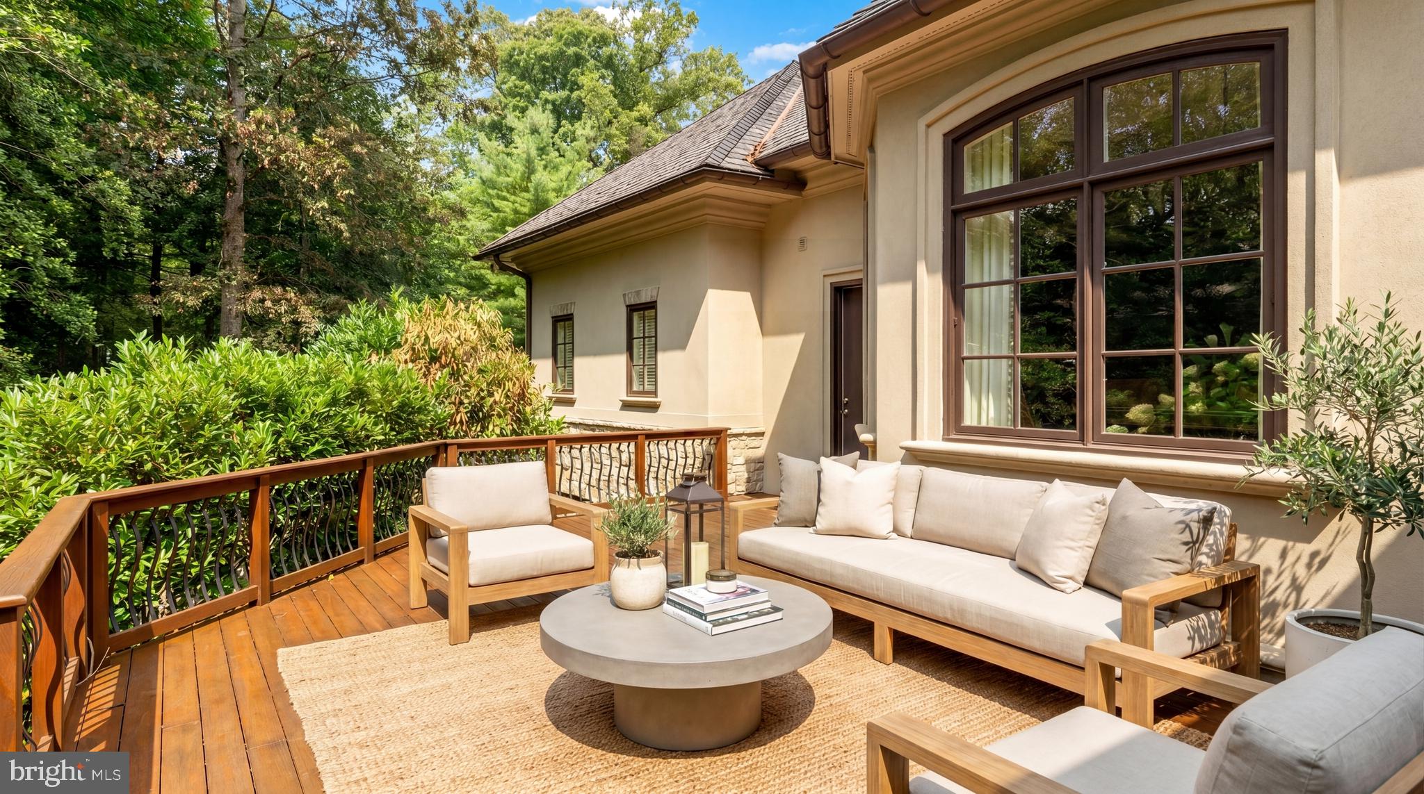 9250 Persimmon Tree Road Potomac, MD 20854 - Photo 17 of 47 a view of a patio with couches table and chairs and potted plants