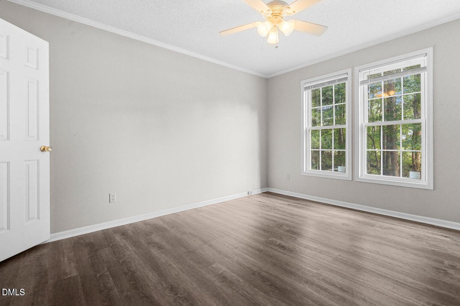 4551 Sugar Maple Road Oxford, NC 27565 - Photo 16 of 23 a view of an empty room with wooden floor and a window