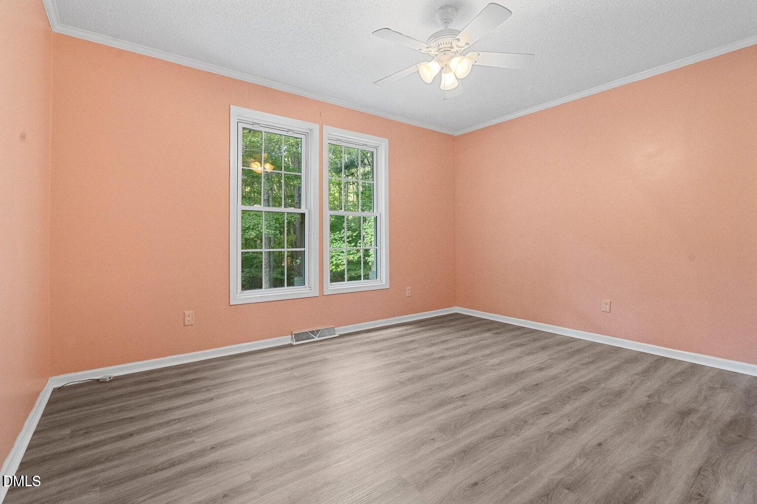 4551 Sugar Maple Road Oxford, NC 27565 - Photo 21 of 23 a view of an empty room with wooden floor and a window