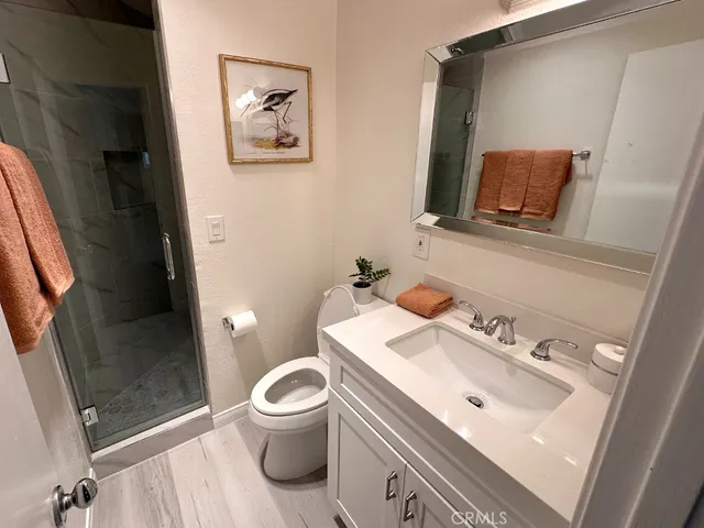 a bathroom with a sink mirror and toilet
