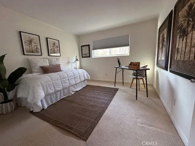 a living room with a bed furniture and a window