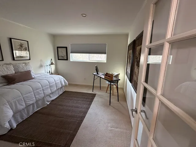 a bedroom with furniture and a flat screen tv