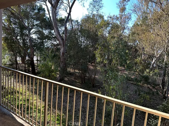a view of a wooden fence and trees