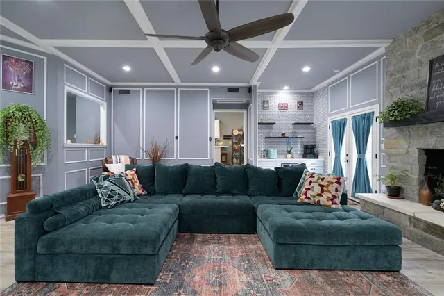 a living room with furniture fireplace and a potted plant
