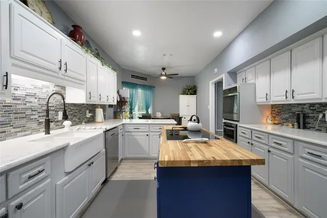 a kitchen with counter top space a sink cabinets and appliances