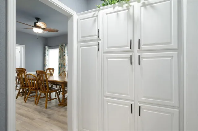 a view of a hallway with dining area