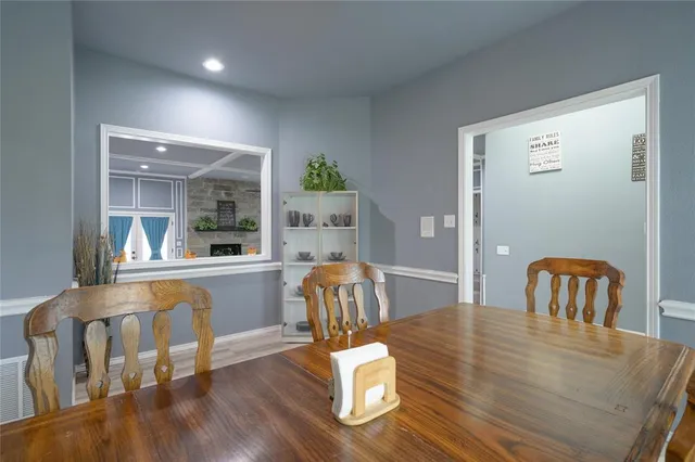 a dining room with furniture and wooden floor