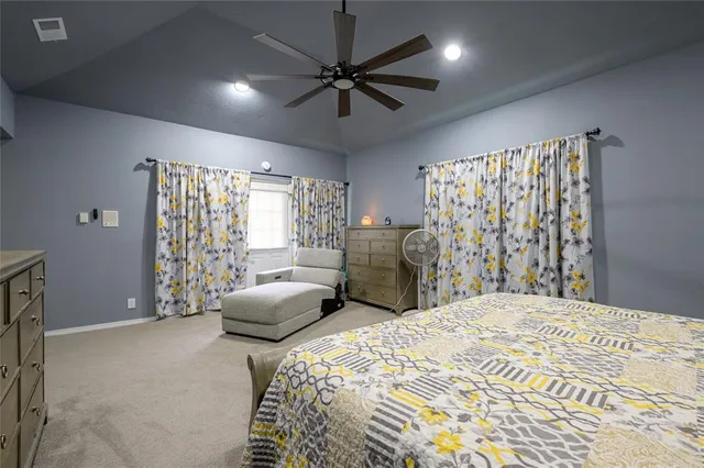 a bedroom with furniture and a large window