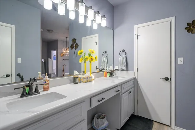 a bathroom with a double vanity sink and a mirror