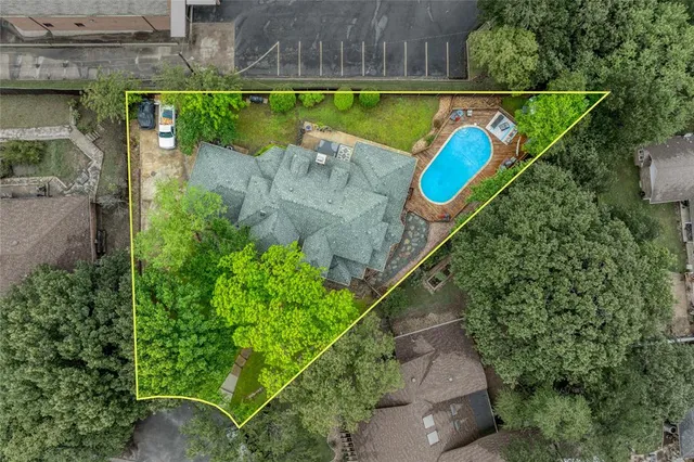 an aerial view of a house with a swimming pool