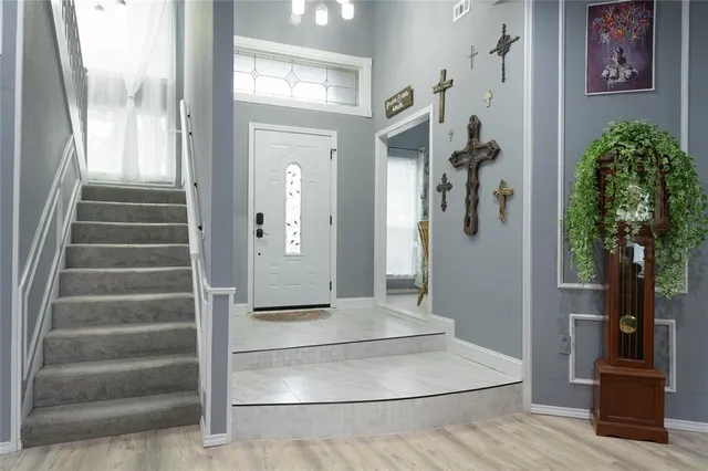 a view of an entryway with wooden floor and a livingroom view