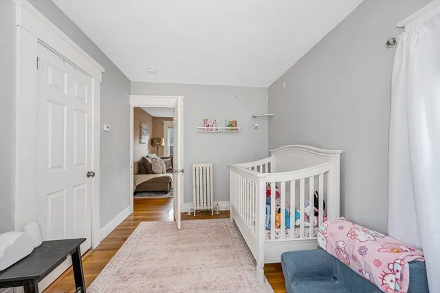 a bedroom with furniture and baby crib