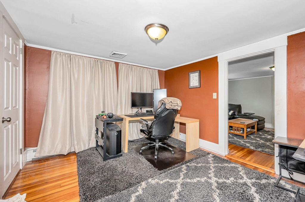 856 Main Street Reading, MA 01867 - Photo 17 of 41 a view of a workspace with furniture and a livingroom