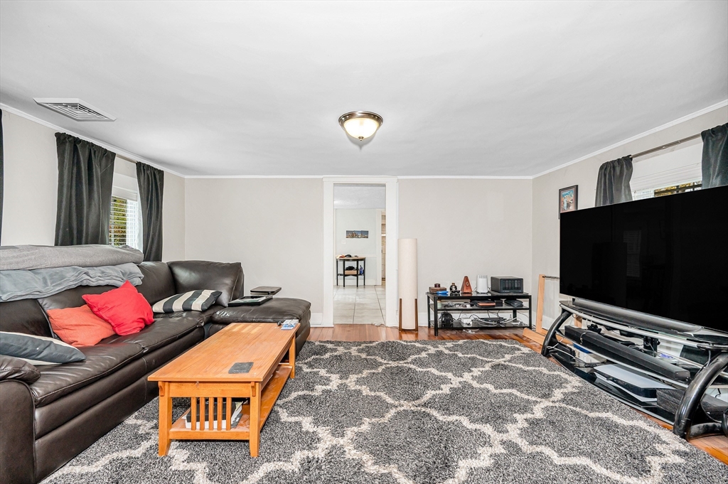 856 Main Street Reading, MA 01867 - Photo 18 of 41 a living room with furniture and a flat screen tv