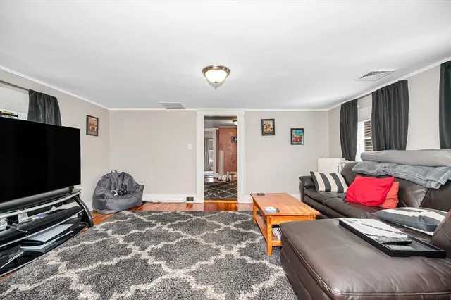 a bedroom with furniture and a flat screen tv