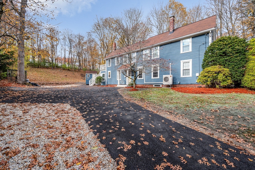 856 Main Street Reading, MA 01867 - Photo 37 of 41 a view of a yard with a house and a tree
