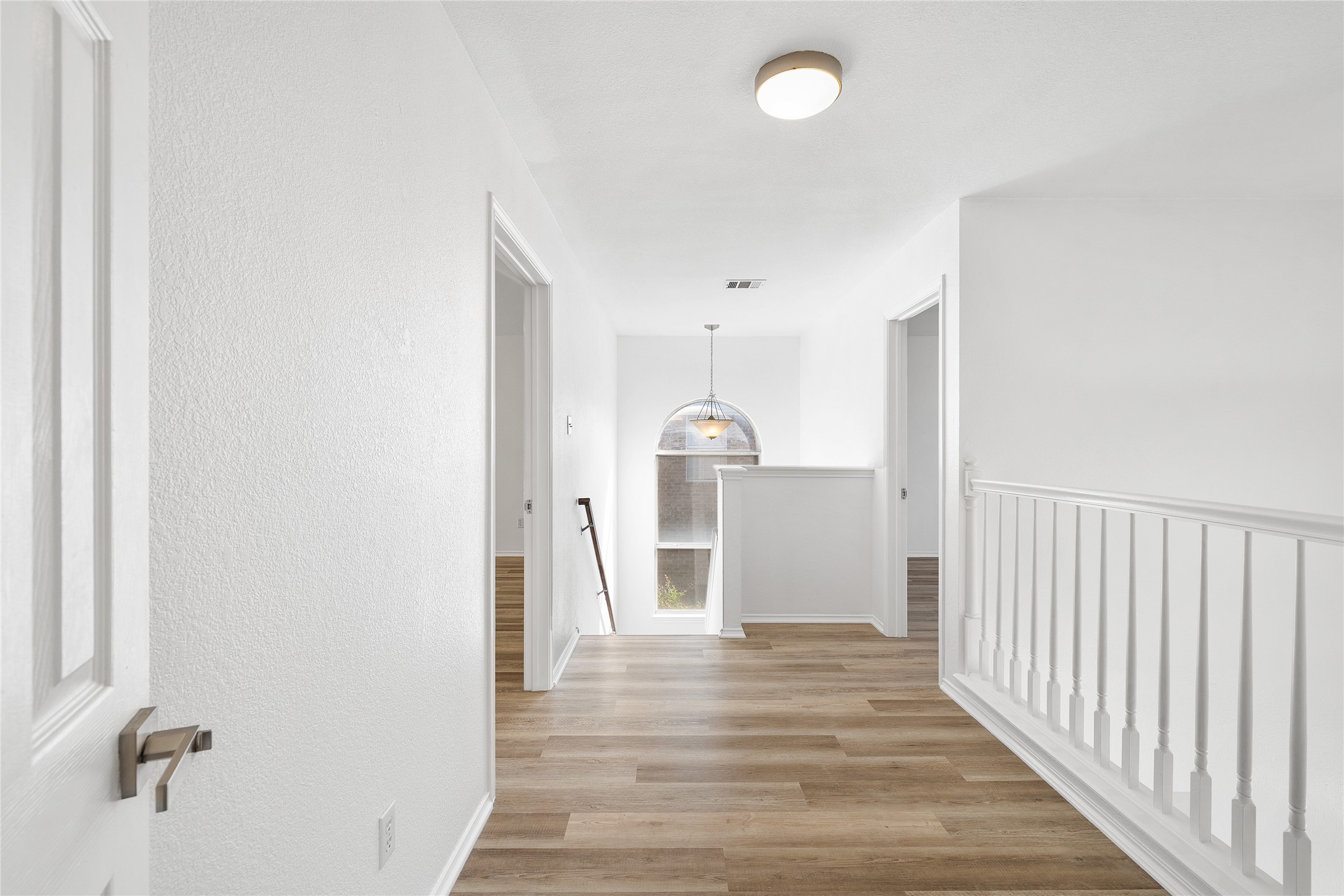 206 River Down Road Georgetown, TX 78628 - Photo 28 of 39 Hallway featuring wood-finish flooring and white textured walls