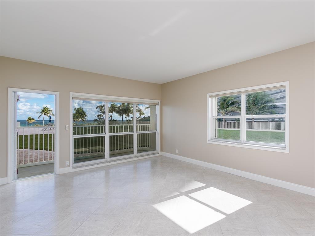 750 North Ocean Boulevard, Unit 210 Pompano Beach, FL 33062 - Photo 13 of 57 an empty room with floor to ceiling window and windows