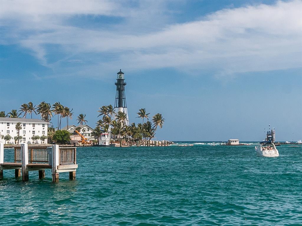 750 North Ocean Boulevard, Unit 210 Pompano Beach, FL 33062 - Photo 19 of 57 a backyard of a house with table and chairs